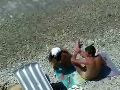 Two teenagers are coupling on the seashore lazily as they didn't sleep the whole night! Maybe they hurry up a little if they know about the spy cam near them!