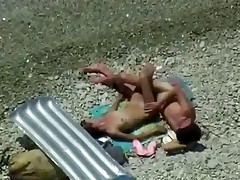 Two teenagers are coupling on the seashore lazily as they didn't sleep the whole night! Maybe they hurry up a little if they know about the spy cam near them!